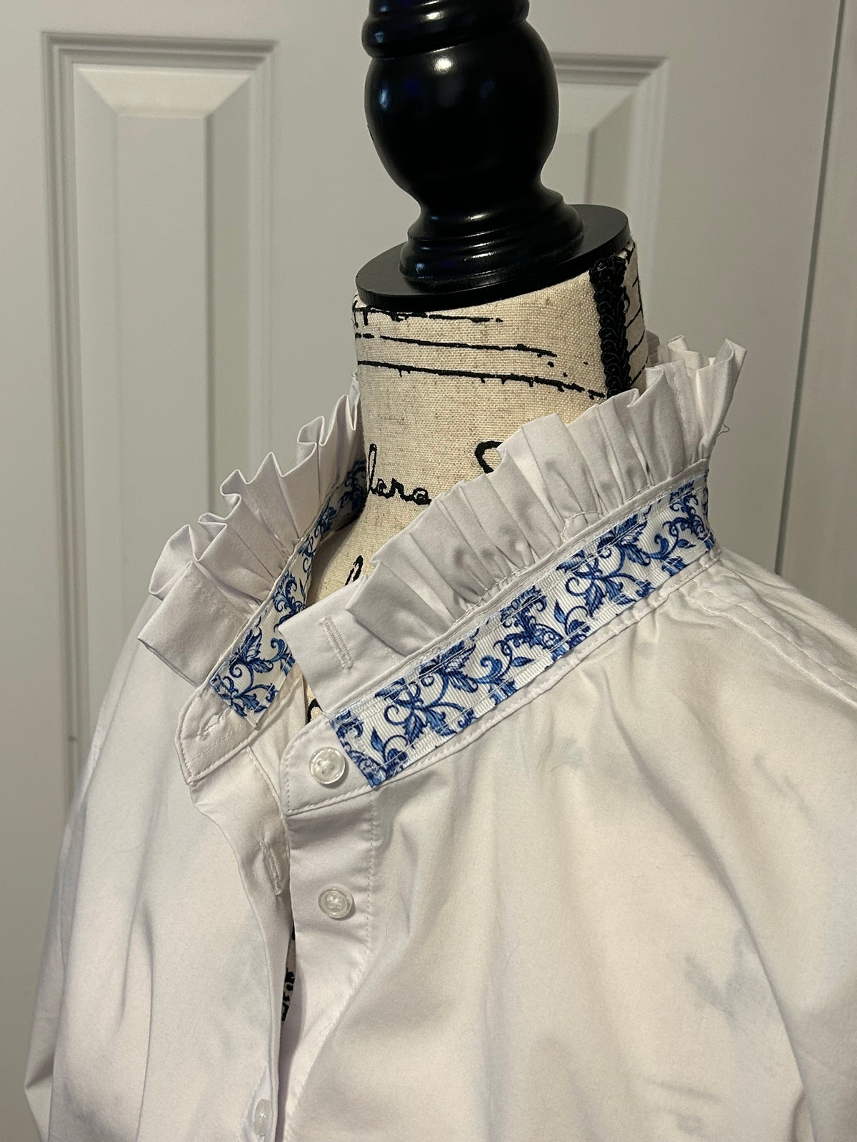 Ladies Up-Cycled White Shirt with White Ruffled Collar and Ruffled Peplum with accents of Blue and White Floral Print.  Size XXL